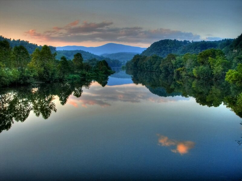 River at dusk with mountain reflection
