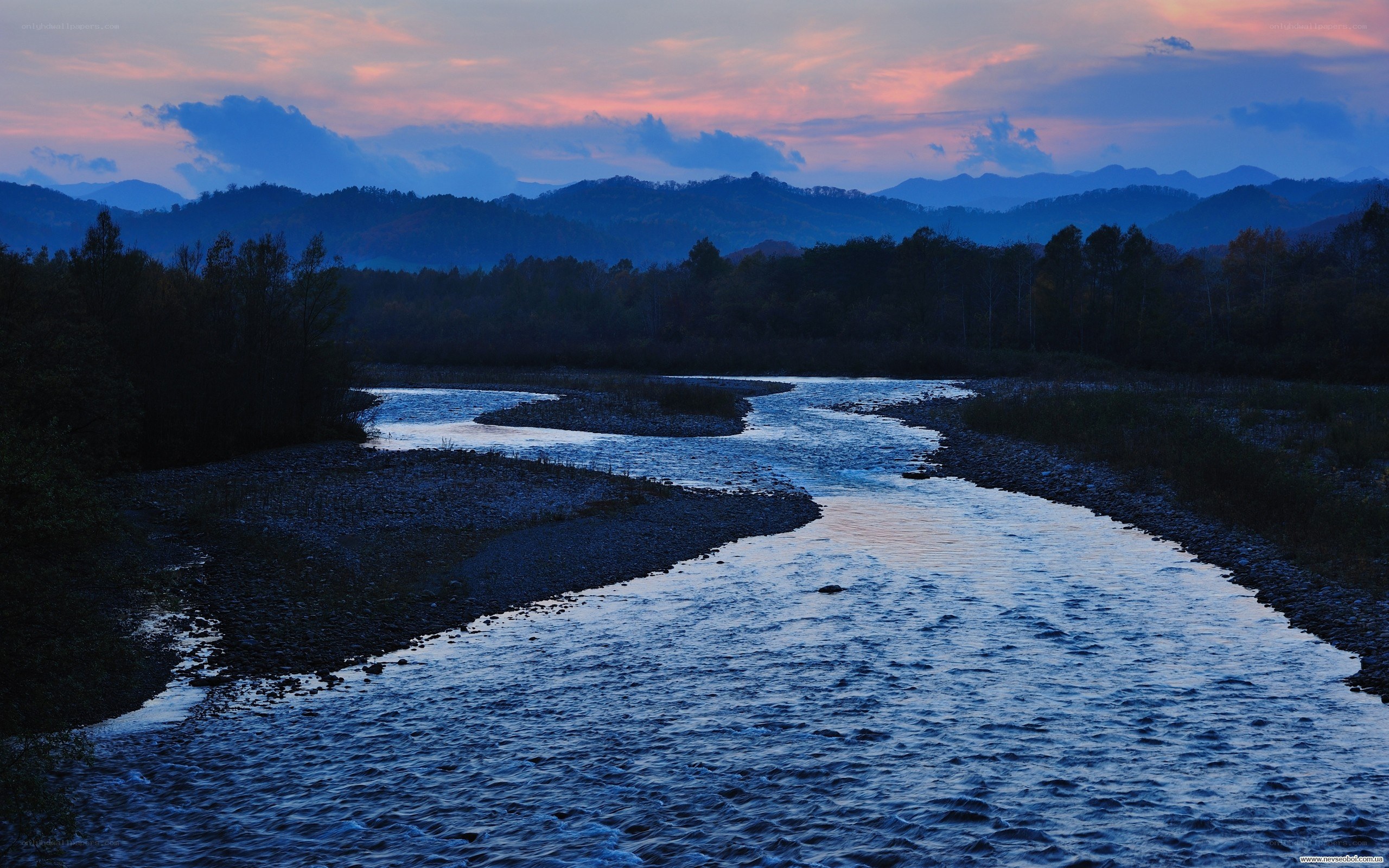 River at dusk with mountains