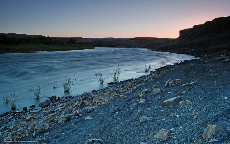 River at dusk with rocky shore