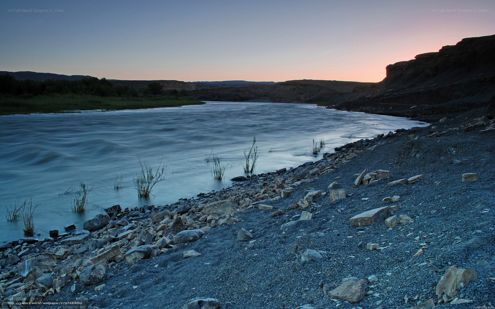 River at dusk with rocky shore