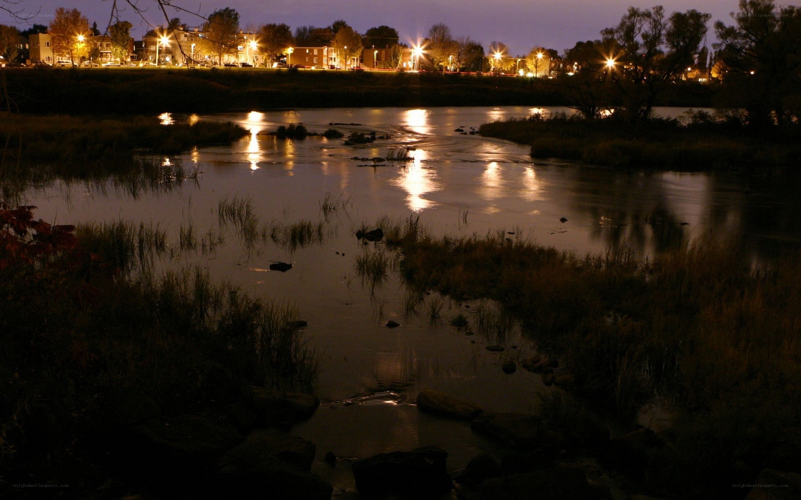 river at night with city lights
