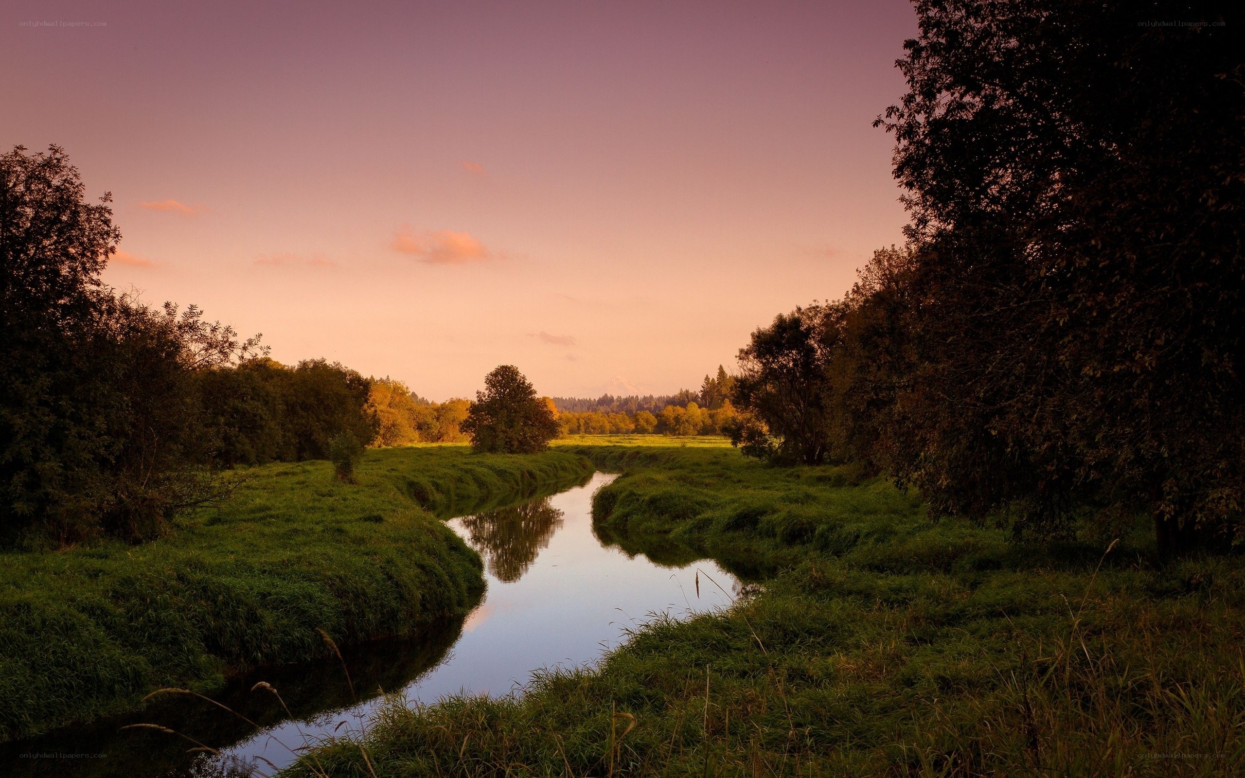River at sunset in a green valley