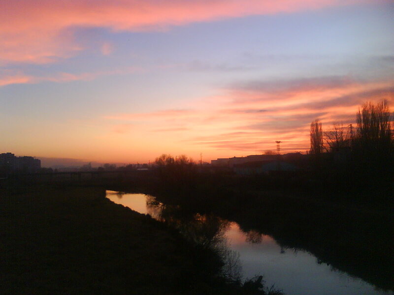 River at Sunset — Orange, Serene, Photograph, Sky, Trees, Buildings