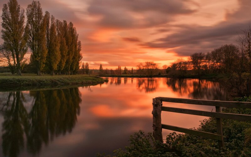 River at Sunset — Orange, Serene, Photograph, Trees, Fence, Sky, Purple