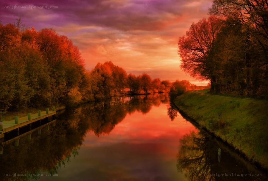 River at sunset with autumn trees