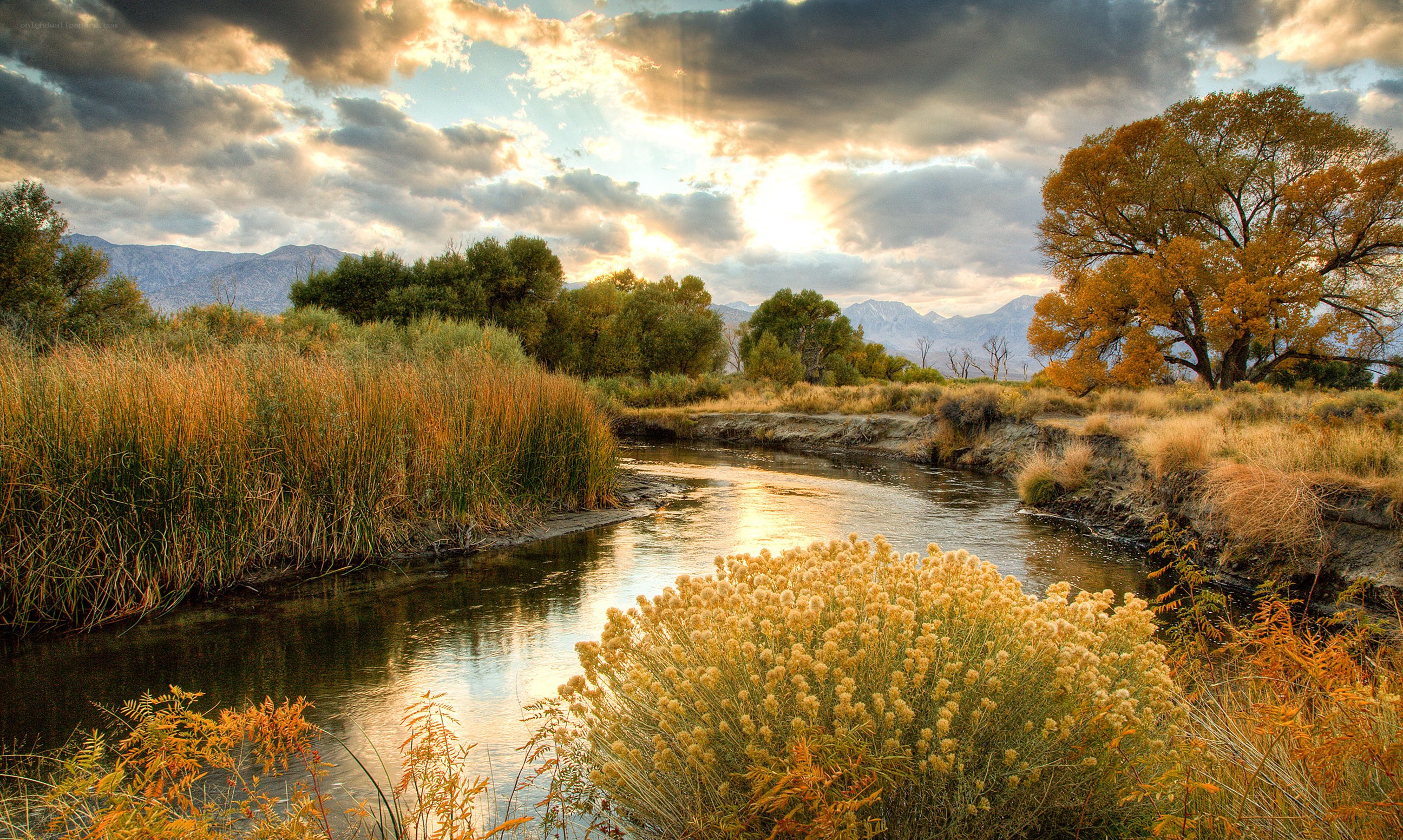 River at sunset with autumn trees