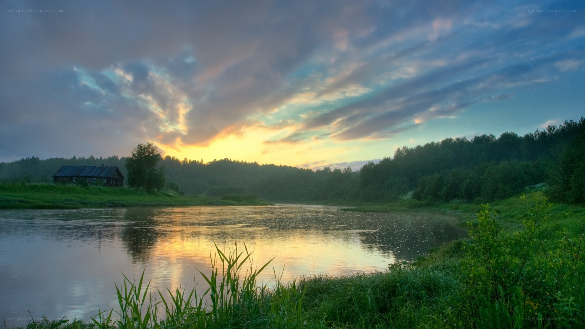 River at sunset with cabin