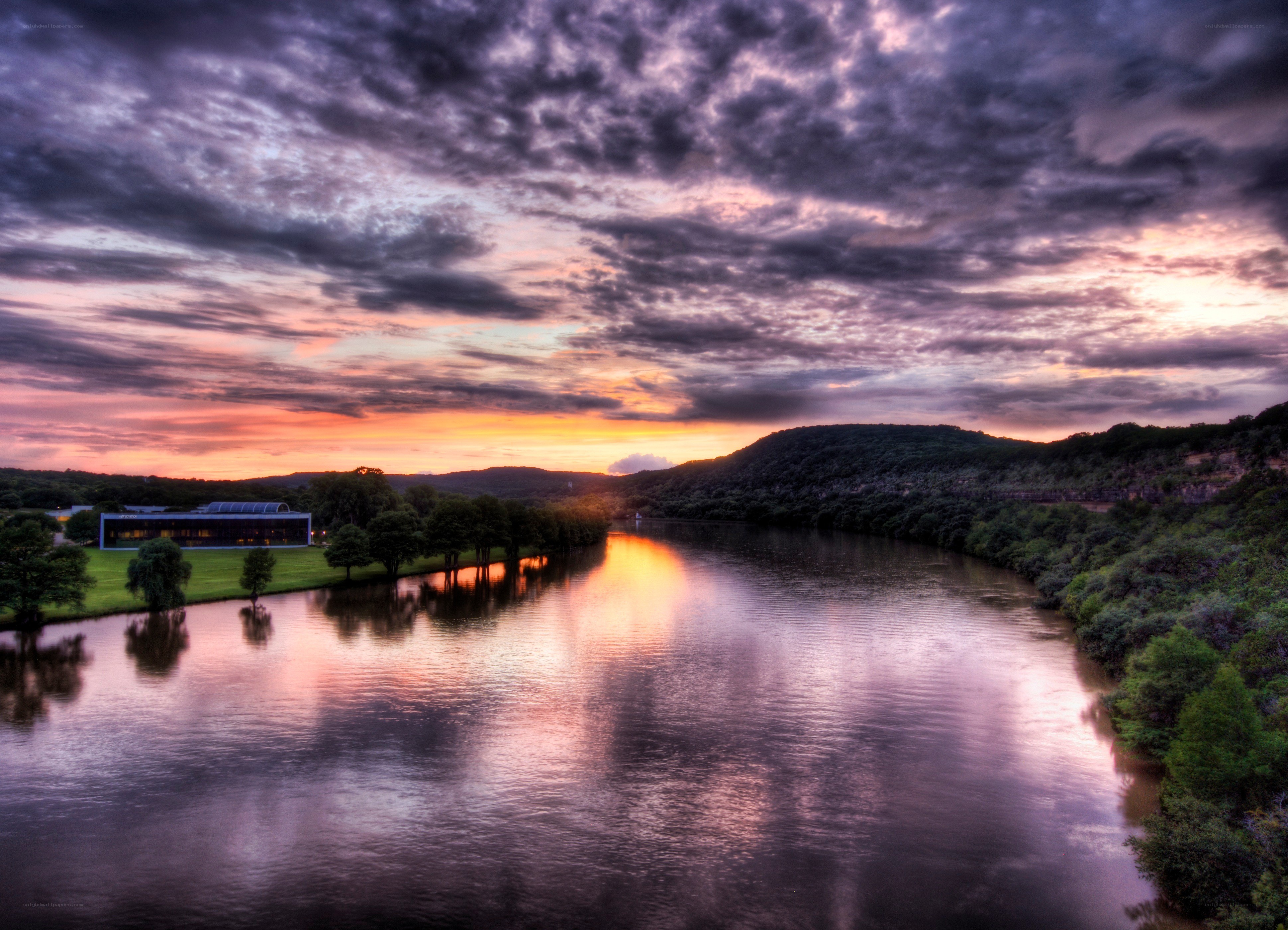 River at sunset with modern building