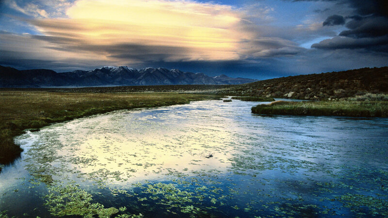 River at sunset with mountains