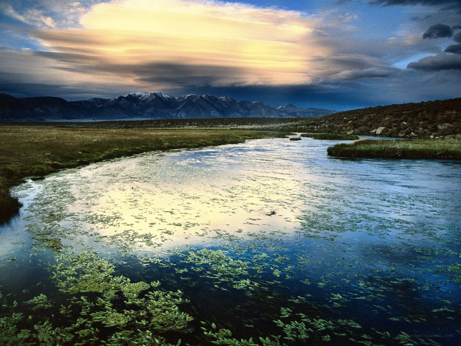 River at sunset with mountains