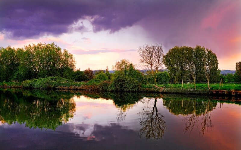 River at sunset with purple sky