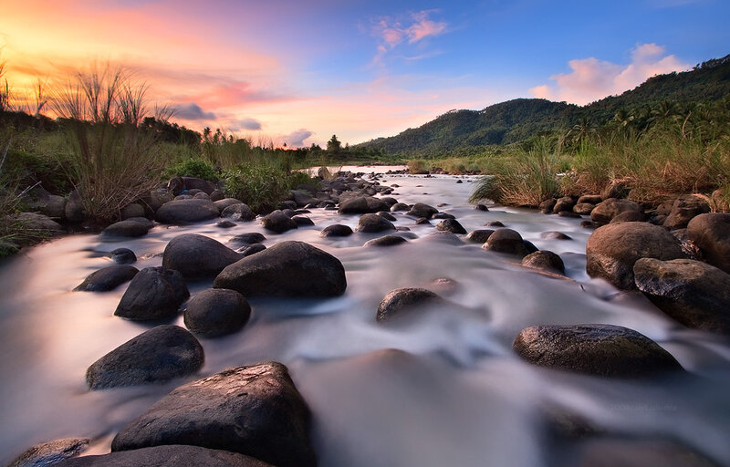River at sunset with rocks