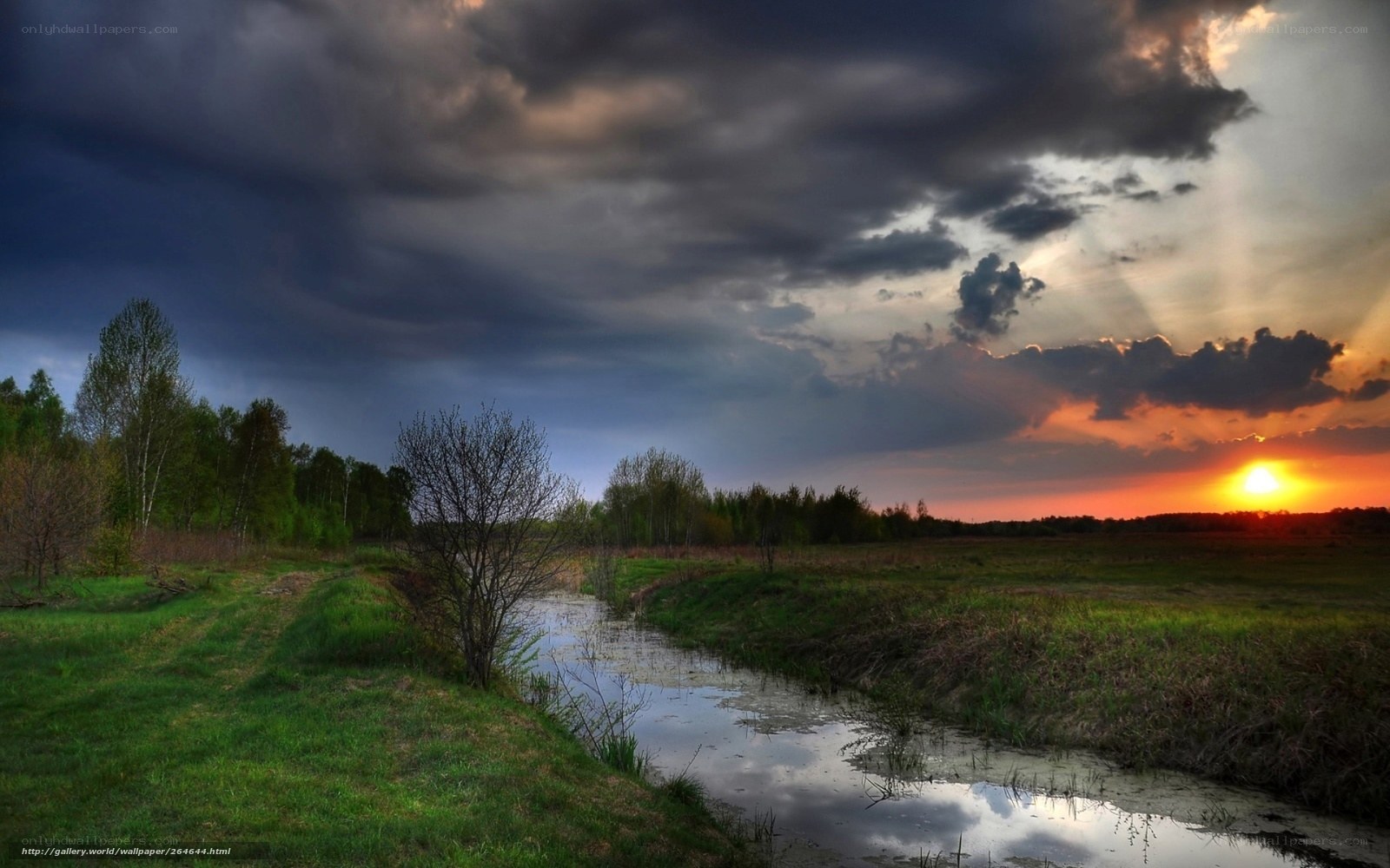 River at sunset with storm clouds