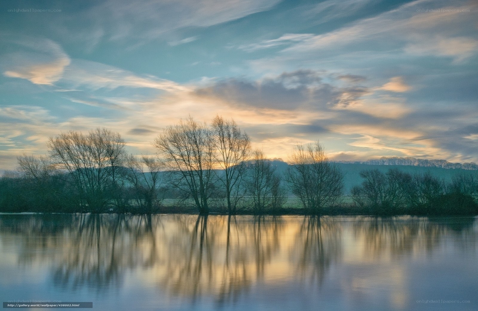 River at sunset with tree reflections