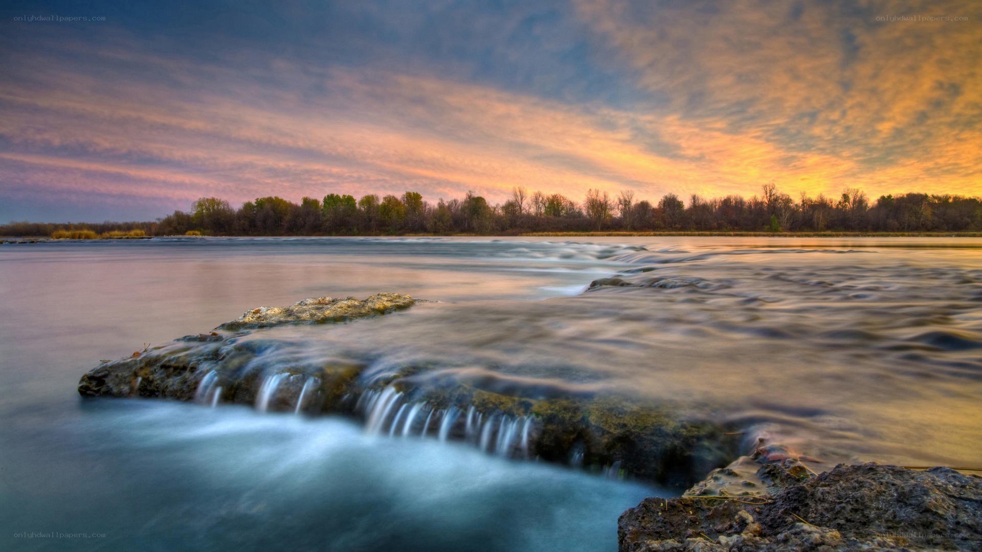 River at sunset with waterfall