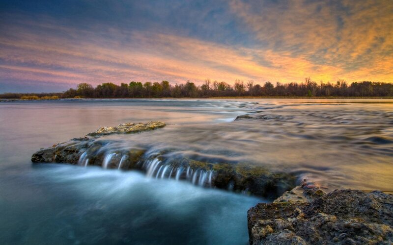 River at sunset with waterfall