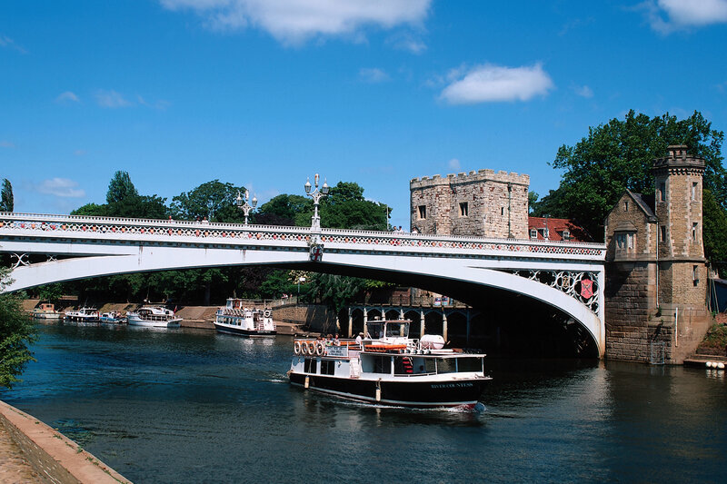 River boat under a stone bridge