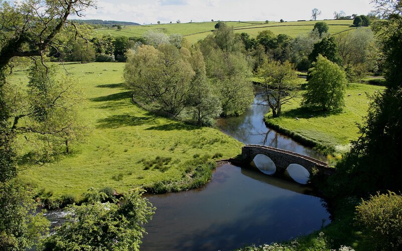 River bridge in green countryside