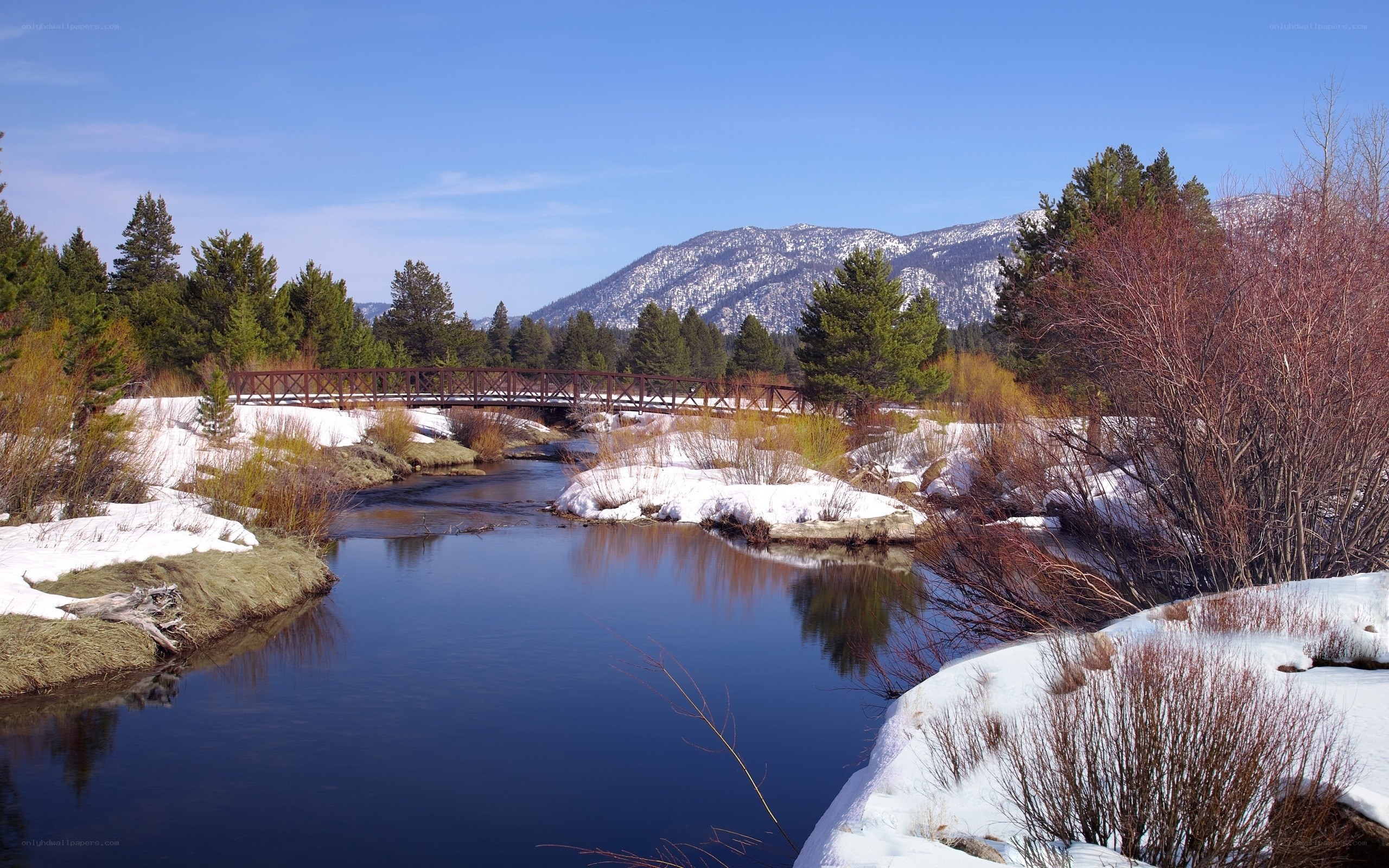 River bridge in snowy mountains