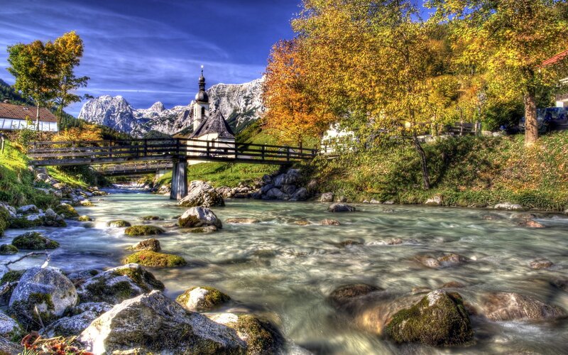 River bridge with church and mountains