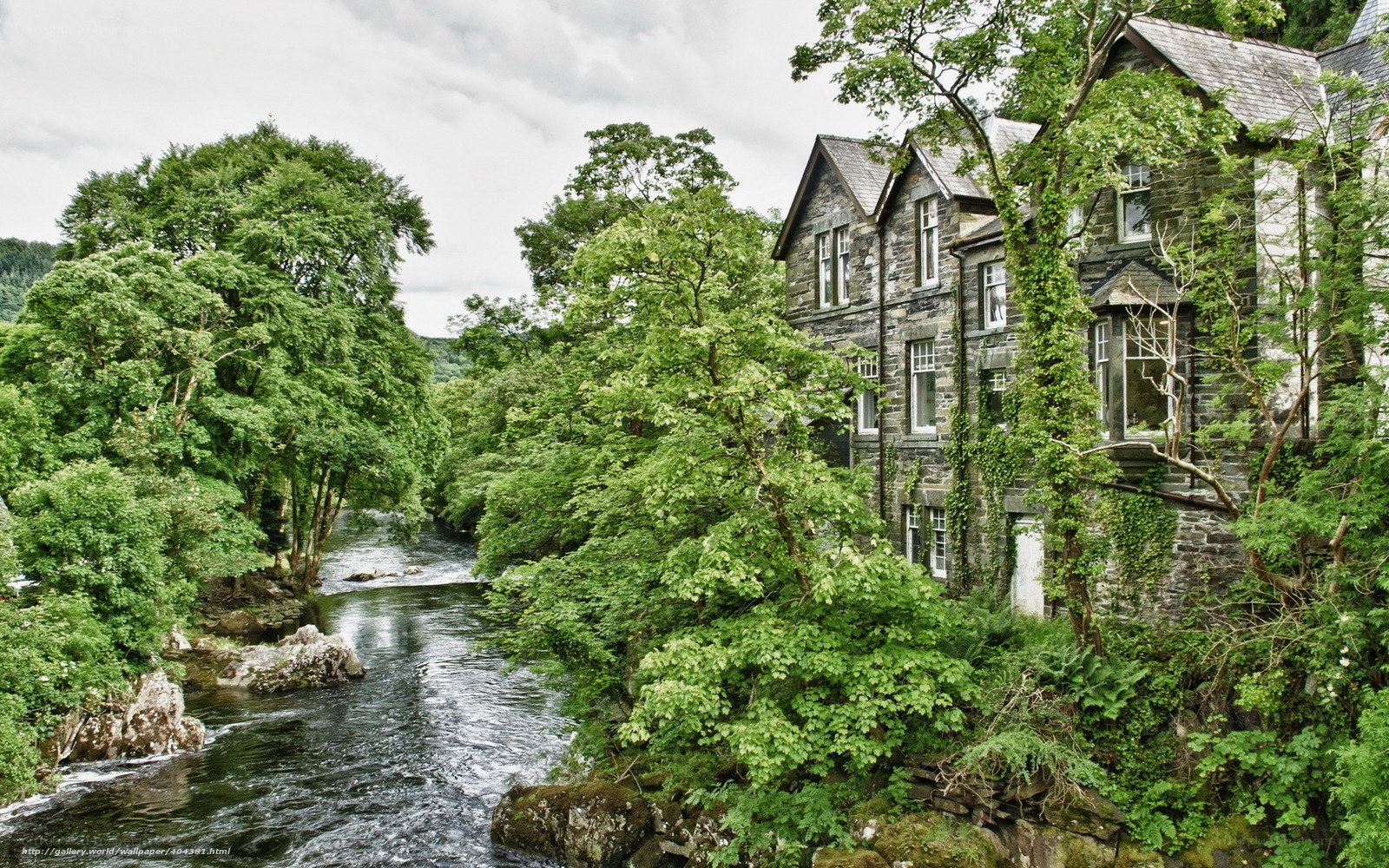 River by stone house