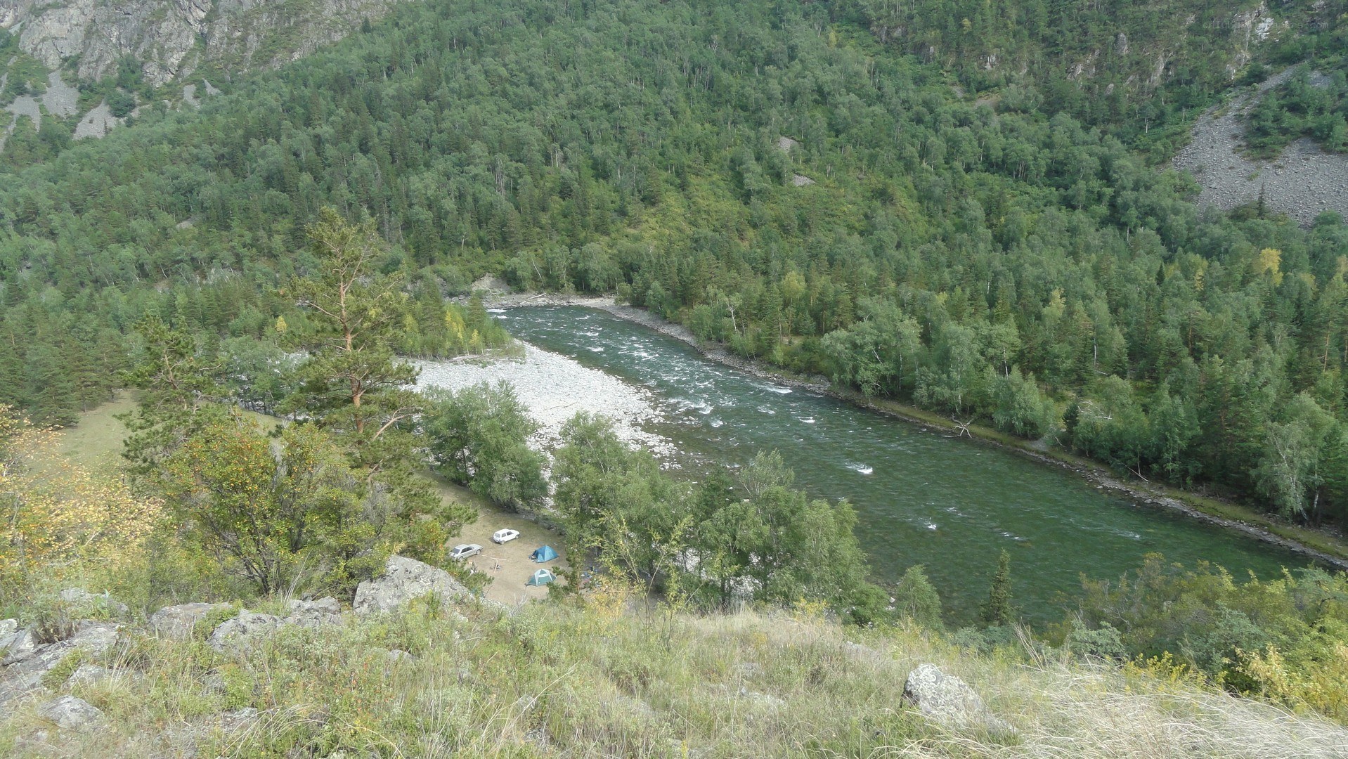 River camp in forested valley