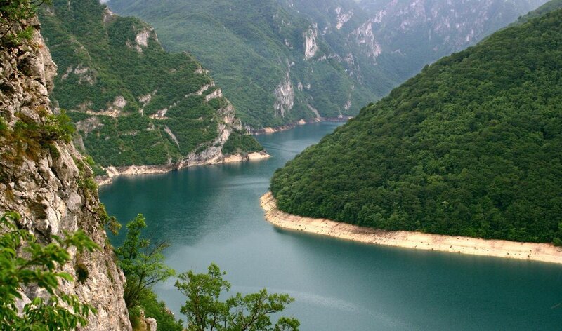 river canyon with lush green hills