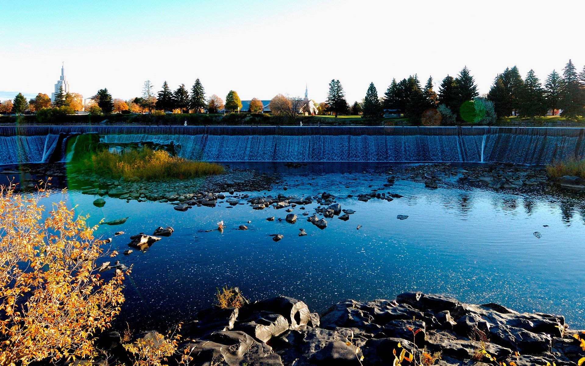 River dam with city skyline
