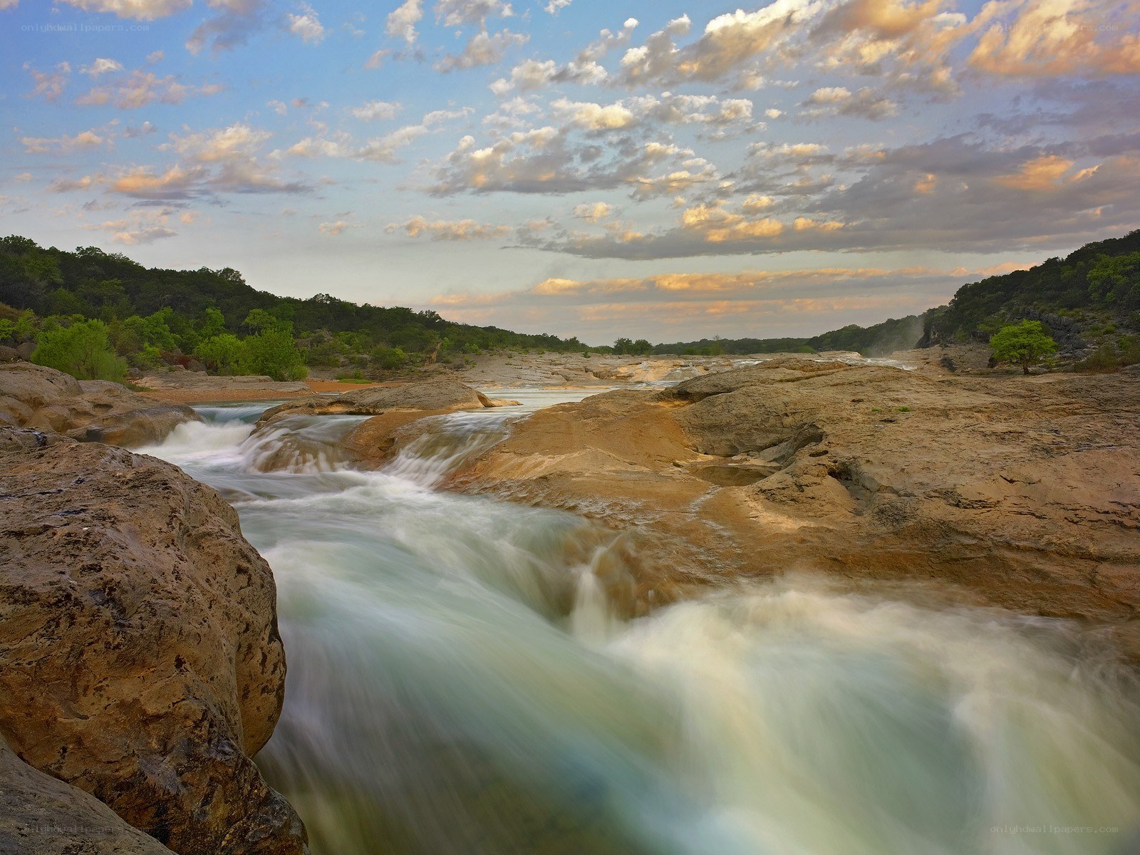 River flowing over rocks at sunset