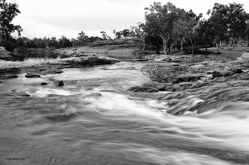 River Flowing over Rocks — Black