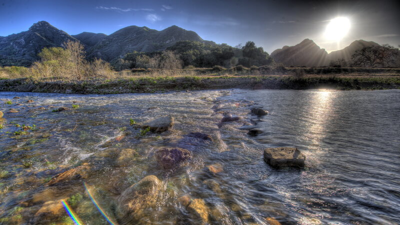 River Flowing over Rocks — Blue, Dramatic, Sunset, Photograph, Mountains