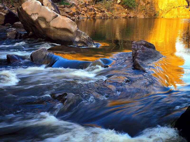 River Flowing over Rocks — Blue, Dramatic, Sunset, Photograph
