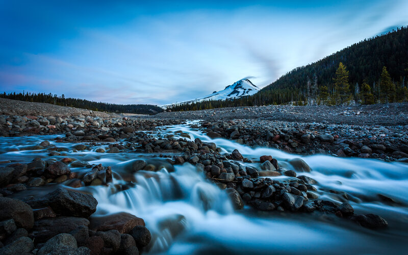 River Flowing over Rocks — Blue, Serene, Sunset, Photograph
