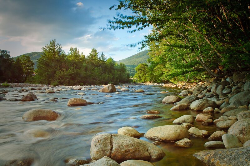 River Flowing over Rocks — Green, Serene, Afternoon, Photograph, Trees, Mountains