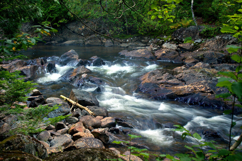 River Flowing over Rocks — Green, Serene, Photograph