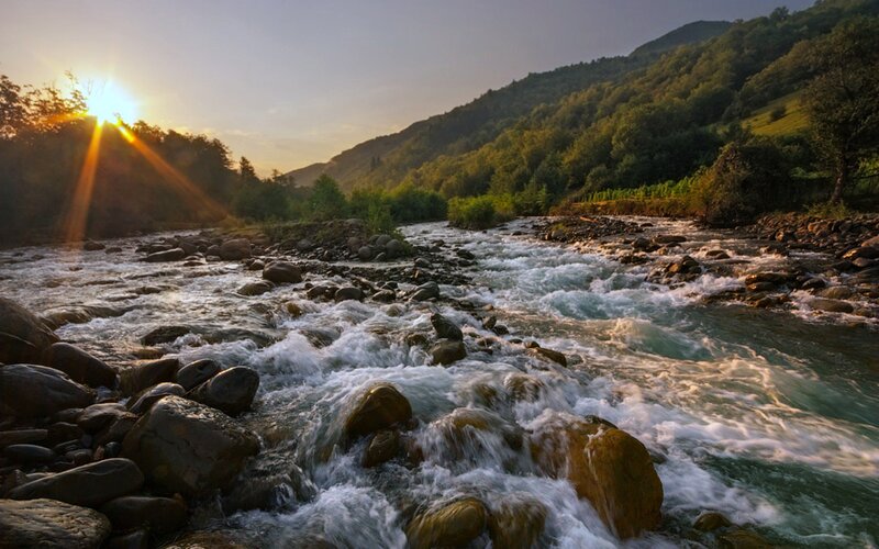 River Flowing over Rocks — Green, Serene, Sunset