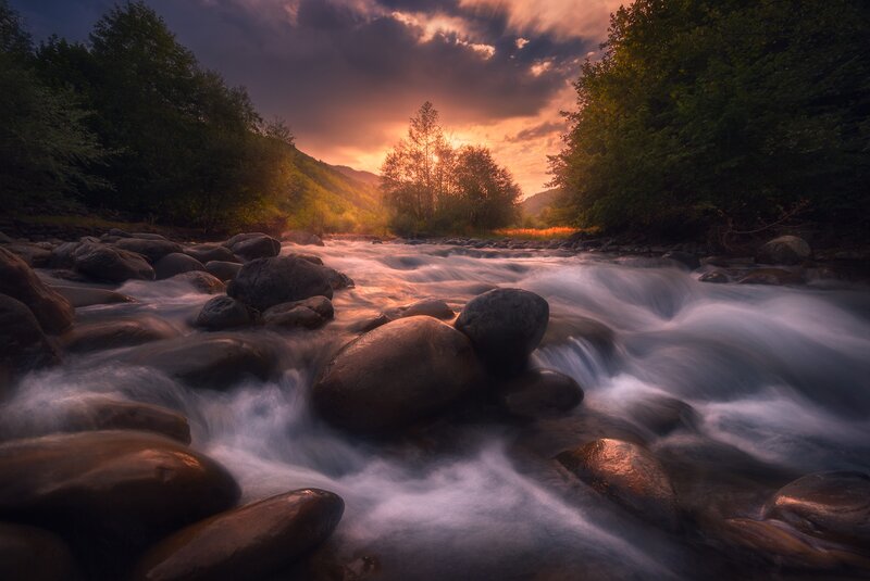 River Flowing over Rocks — Orange, Dramatic, Sunset, Photograph, Trees