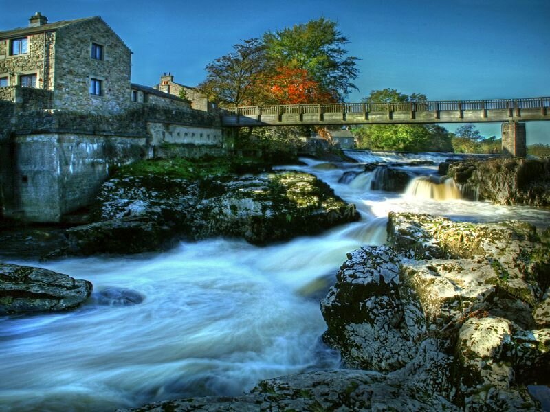 River flowing over rocks with bridge