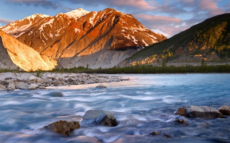 River Flowing Past Mountains