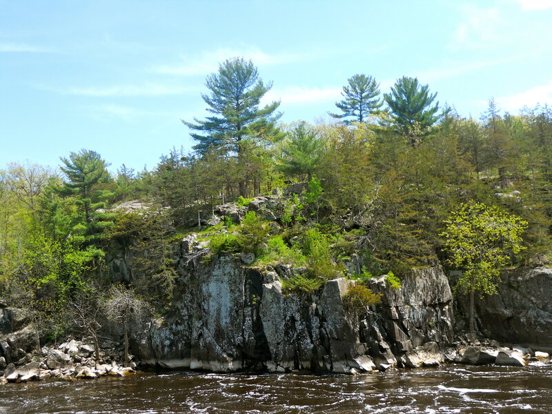 River Flowing Past Rocky Cliff — Green
