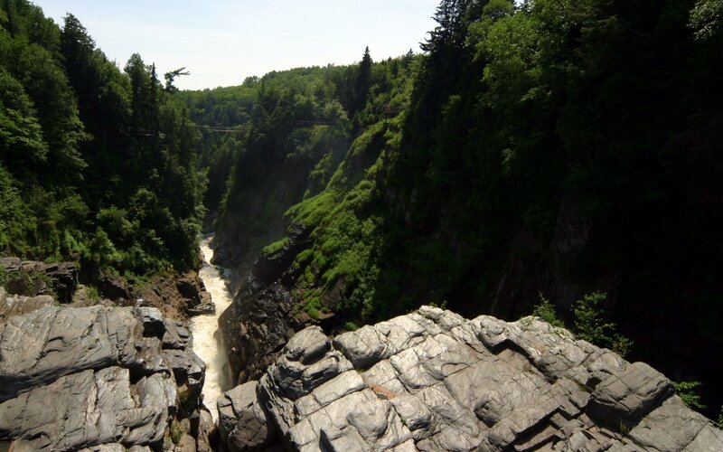 river flowing through a forested canyon