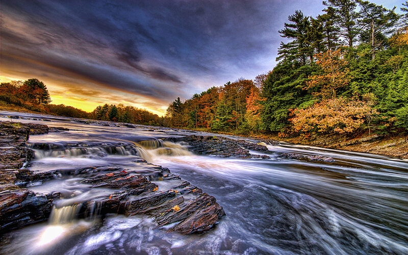 River flowing through autumn forest