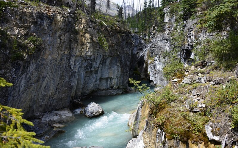 River Flowing Through Canyon — Blue, Natural, Afternoon, Photograph, Trees, Bridge