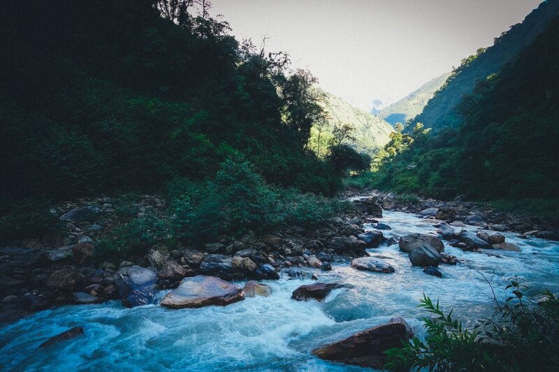 River Flowing Through Canyon — Blue, Serene, Afternoon, Photograph, Rocks, Trees, Mountains