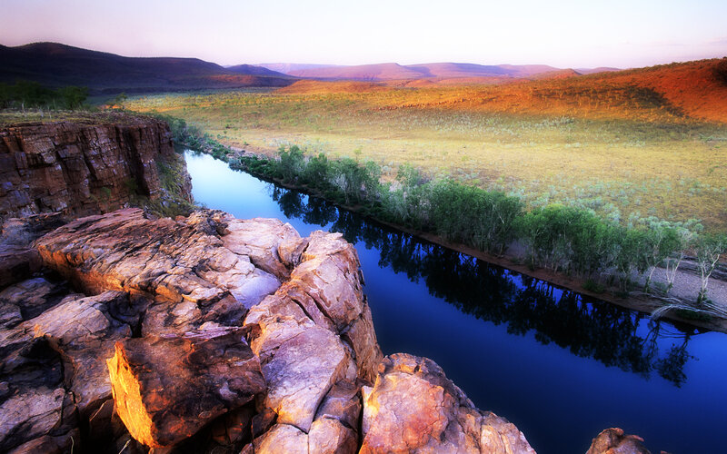 River Flowing Through Canyon — Blue, Serene, Sunset, Photograph, Cliffs, Trees