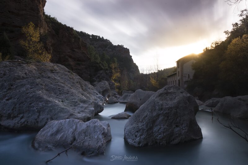 River Flowing Through Canyon — Gray, Serene, Sunset, Photograph