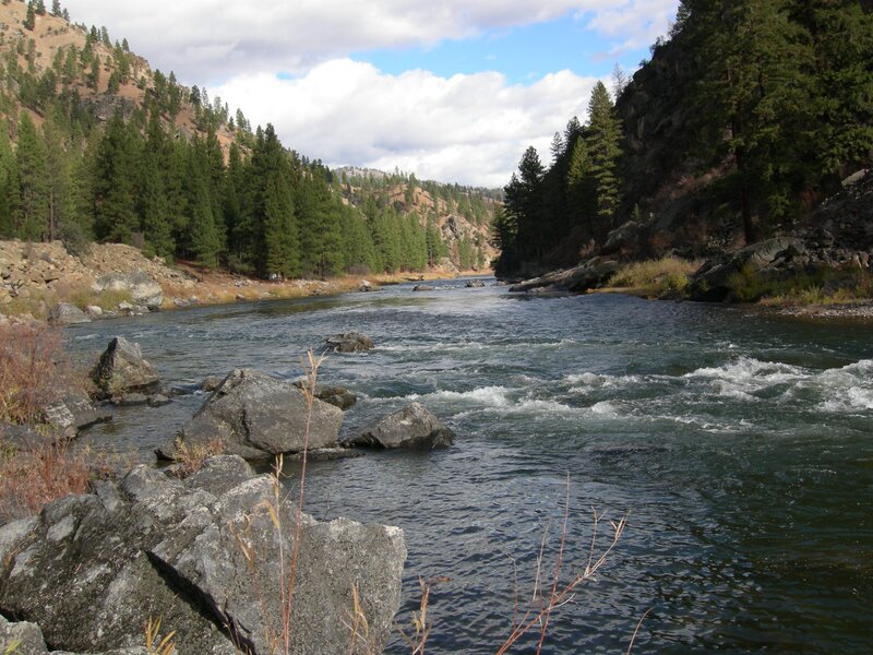 River Flowing Through Canyon — Green, Serene, Afternoon, Photograph, Trees, Rocks, Sky