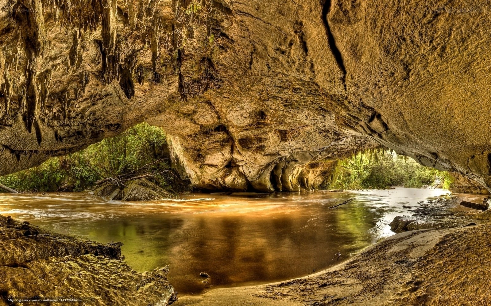 River flowing through cave arch