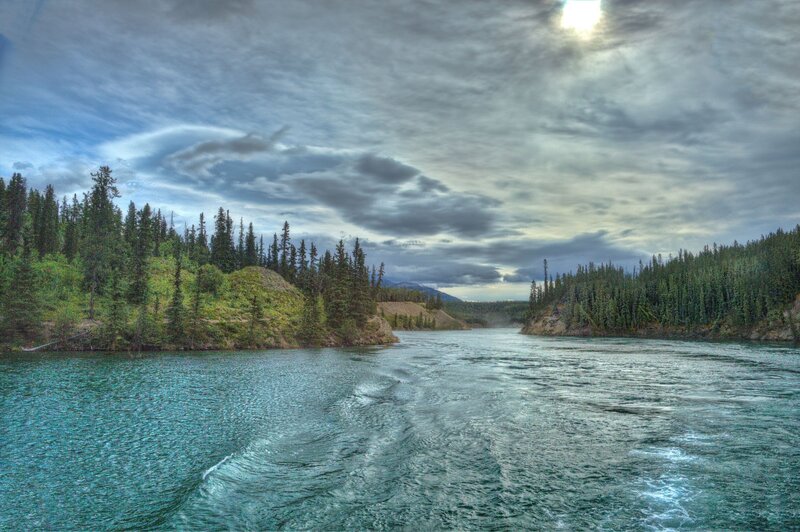 River Flowing Through Forest — Blue, Dramatic, Afternoon, Photograph, Trees