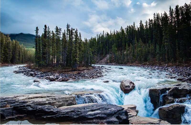 River Flowing Through Forest — Blue, Dramatic, Photograph